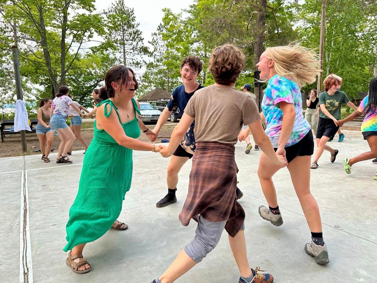 People holding hands and dancing in a circle