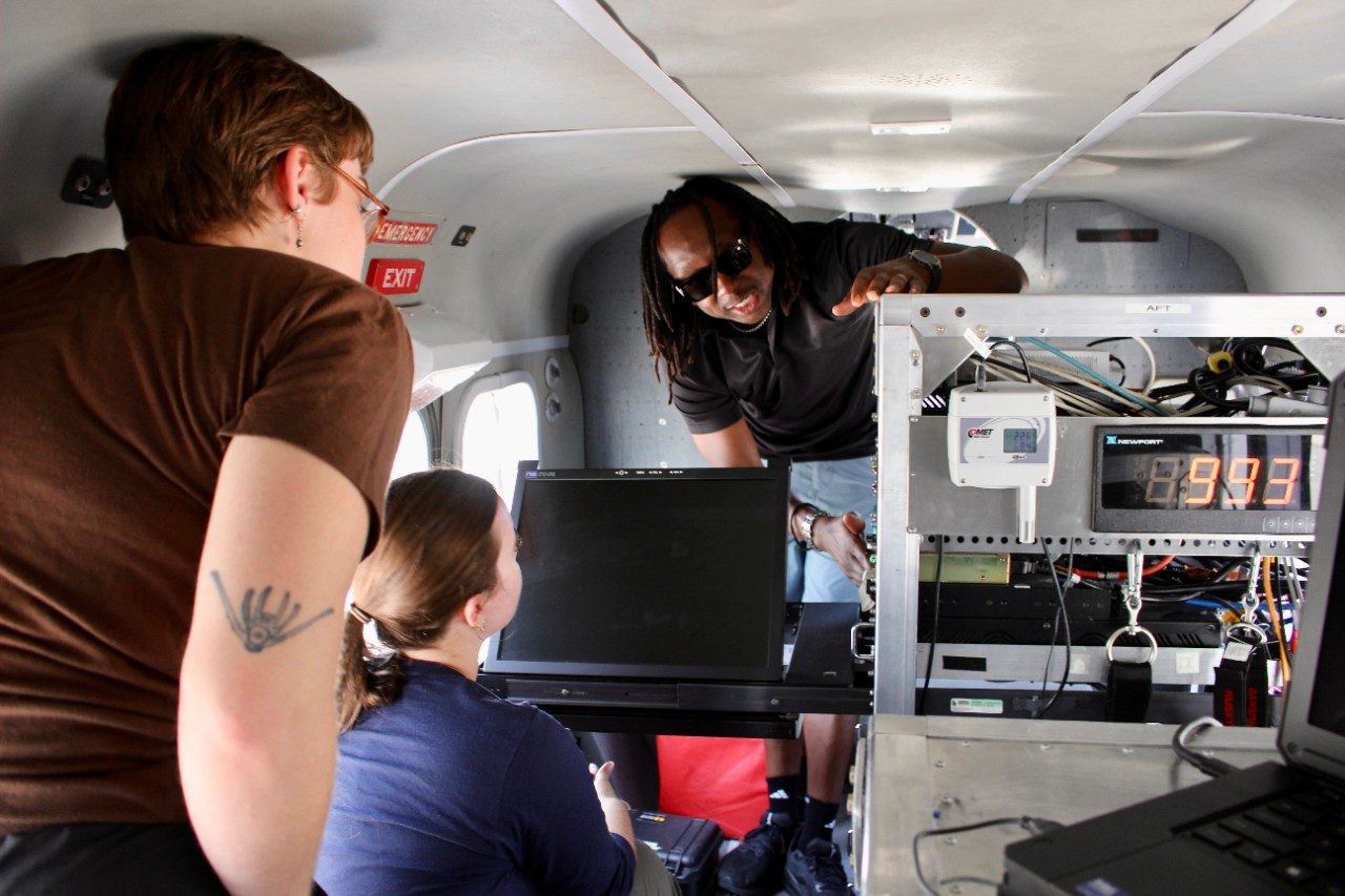 People looking at research equipment