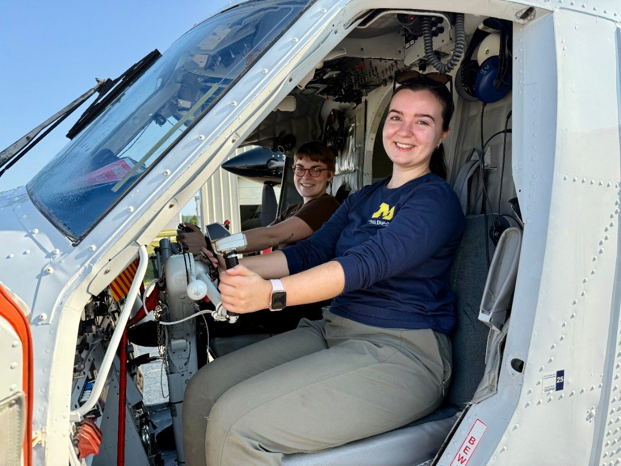 Two people in the cockpit of a plane