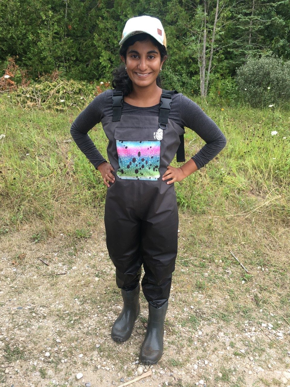 Woman wearing hip waders in a forest