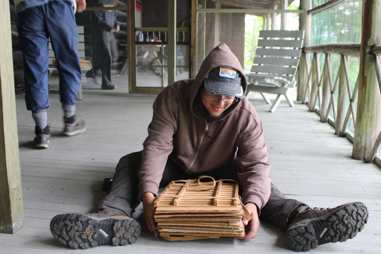 Person sitting on the floor with a plant press