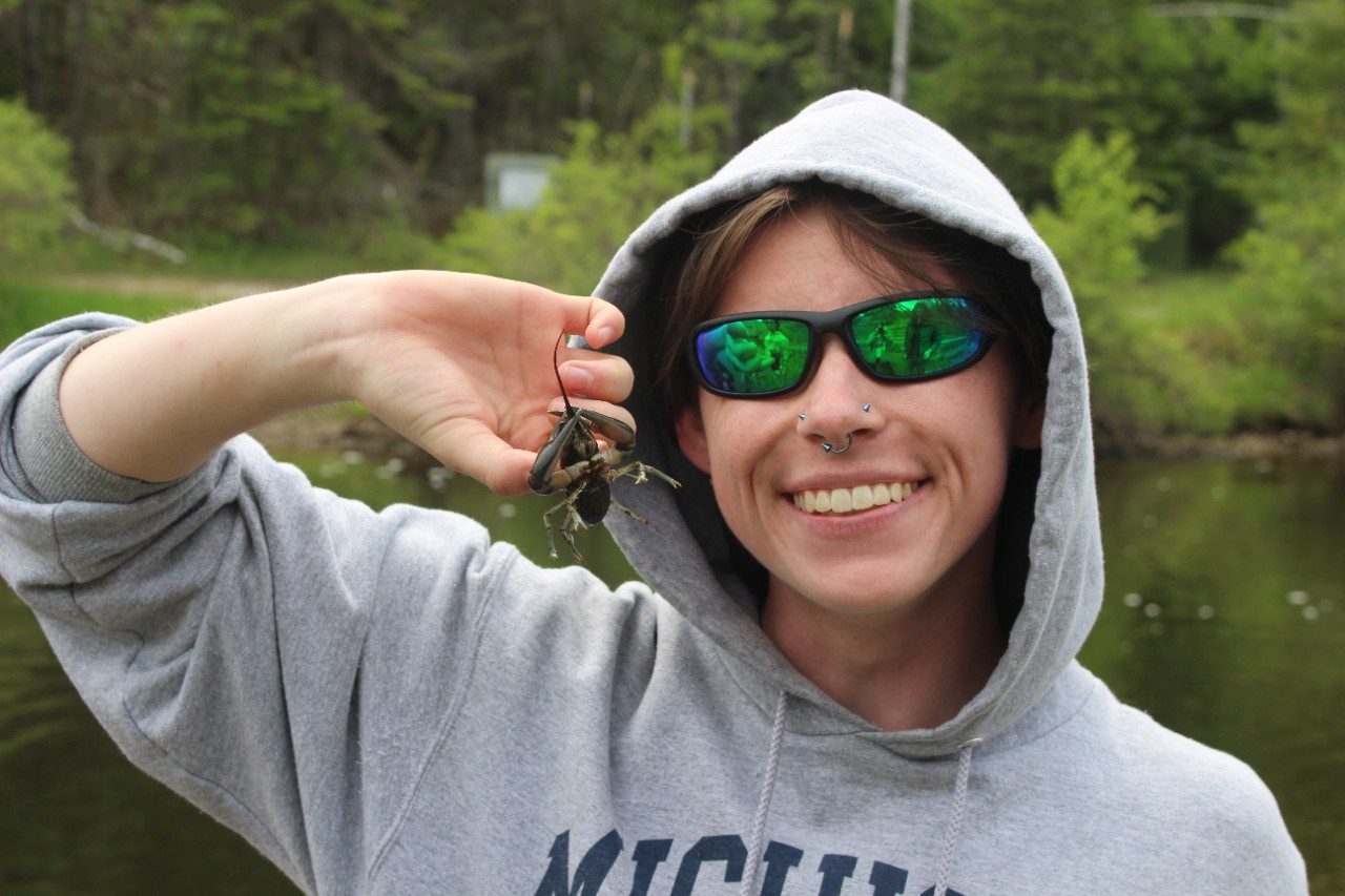 Person holding up a crayfish