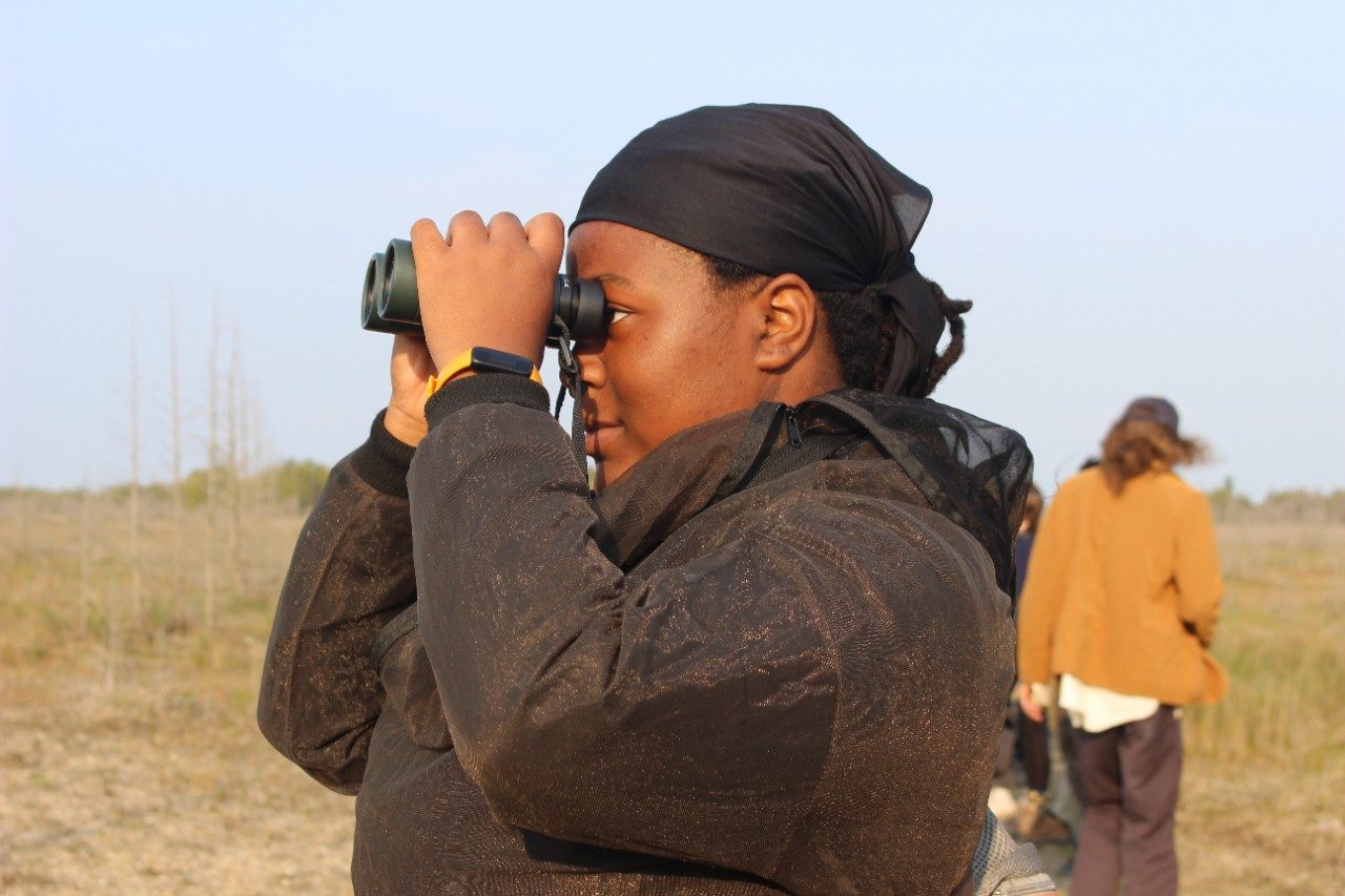 Person looking into binoculars
