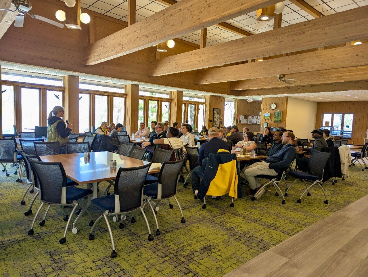 Group in a dining hall, sitting at tables