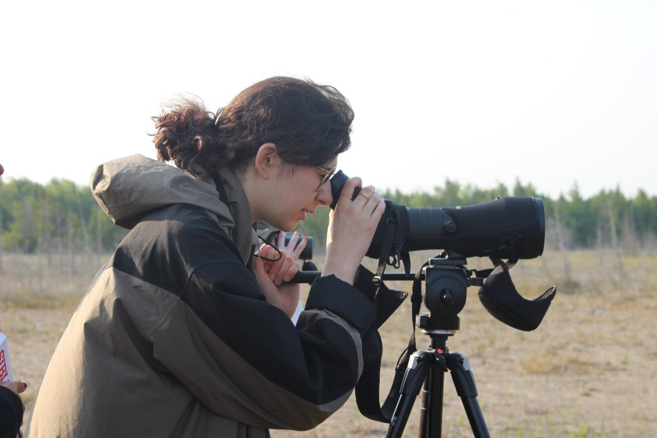 Person looking through binoculars