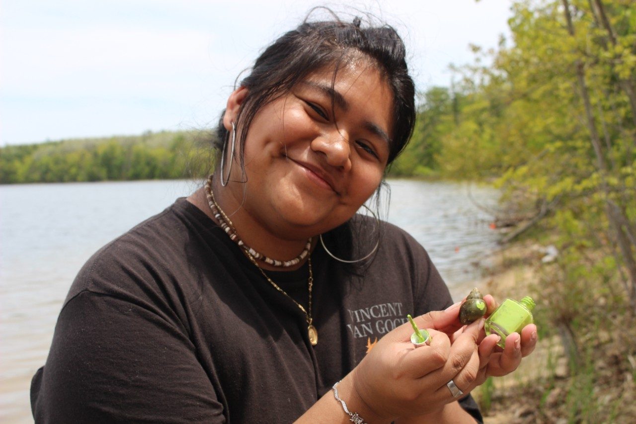 Person marking a snail with nail polish
