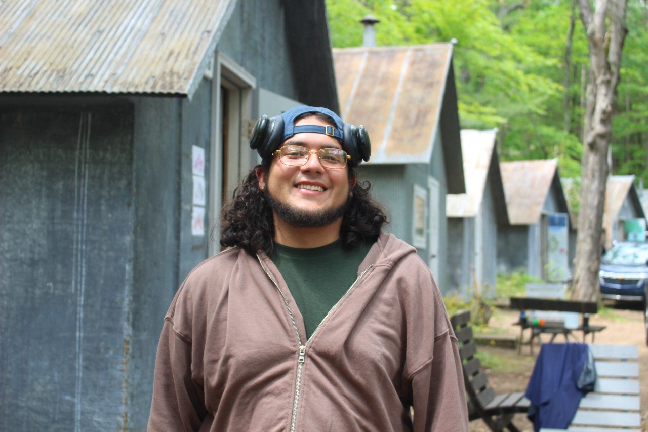 Person standing outside in front of cabins