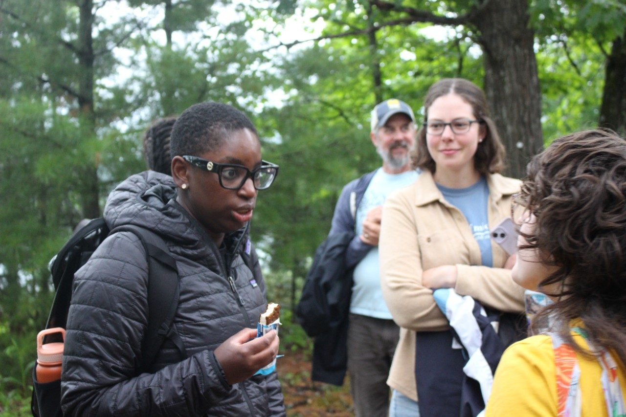 Person talking to a group of people outside