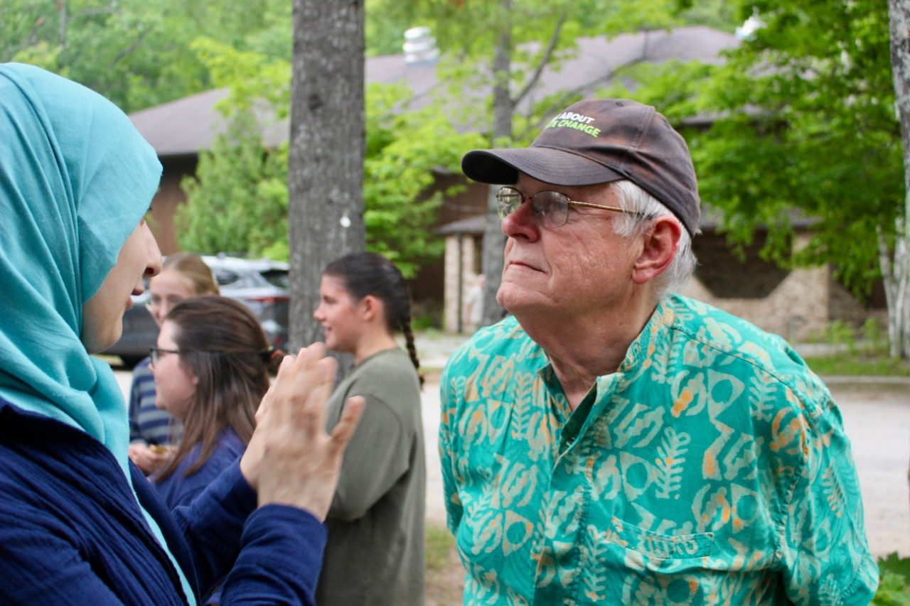 Two people having a conversation outside