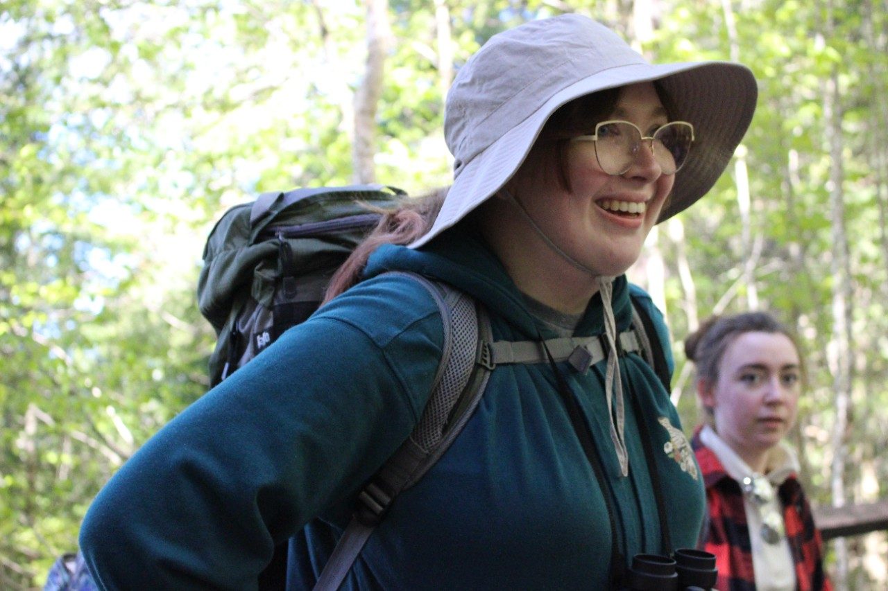 Person smiling in a forest