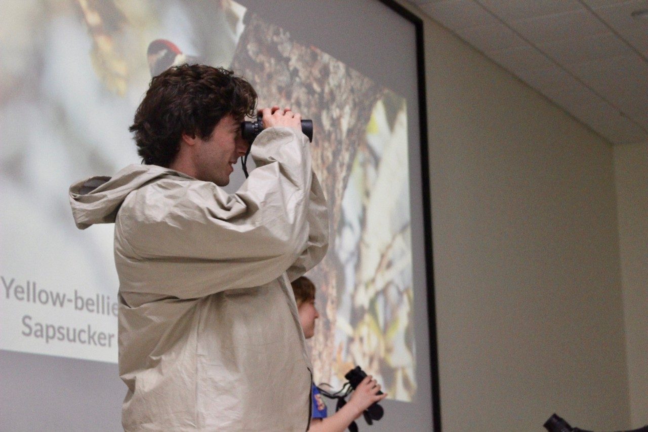 Person looking through binoculars