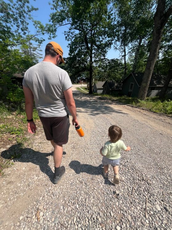 Father and son walking down a road
