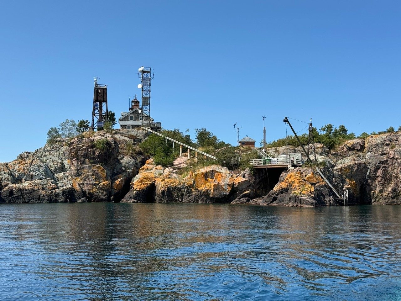 Rocky island from the view of a boat approaching the island on a lake