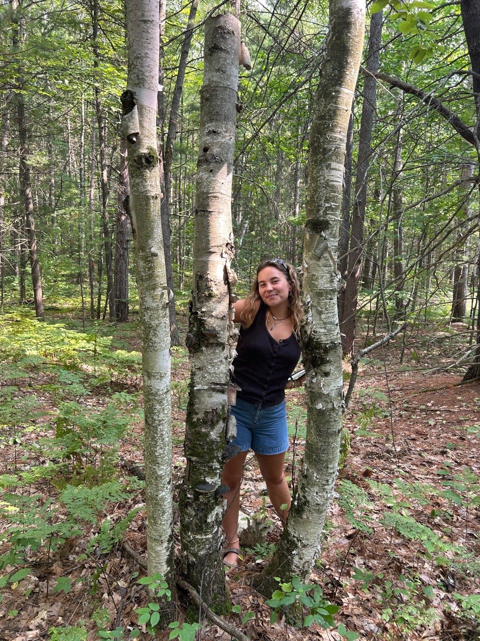 Woman posing with a tree
