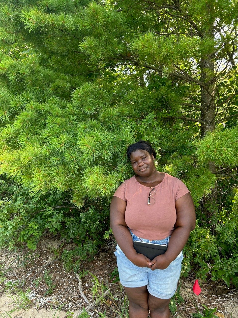 Woman standing in front of a tree