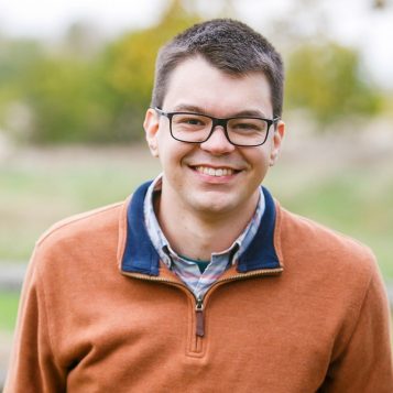 Head shot photo of a man outside
