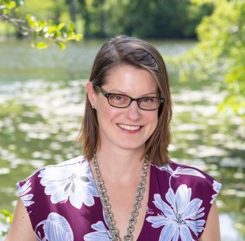 Headshot photo of a woman in front of a lake