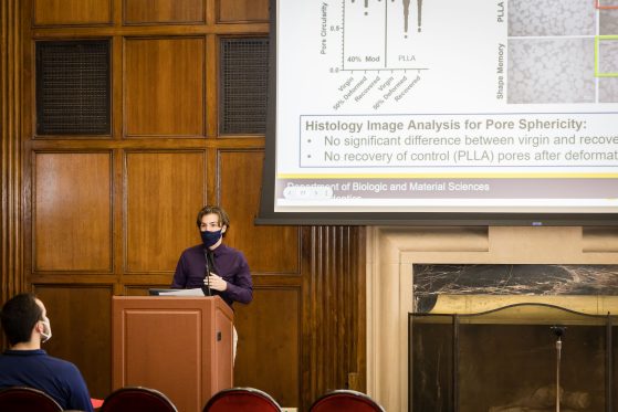 Student at the podium presenting at the UROP Symposium