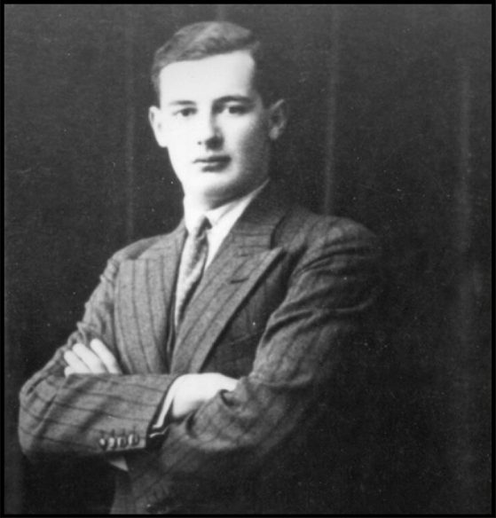 A black and white photo of Raoul Wallenberg, He is wearing a striped suit and a tie. He's looking towards the camera with his arms crossed.