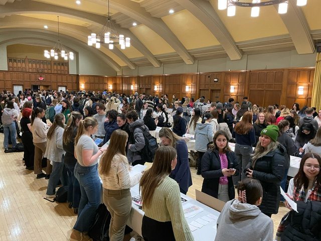 Ballroom with people crowding around tables
