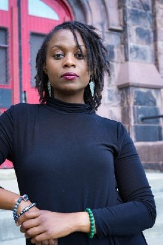 Jennifer Jones in a black shirt posing outdoors