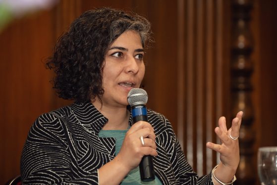 Seda Sulak pictured with a microphone speaking in front of a crowd.