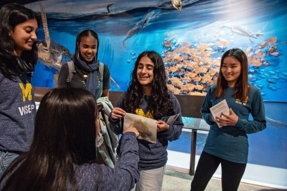 students in front of an aquarium